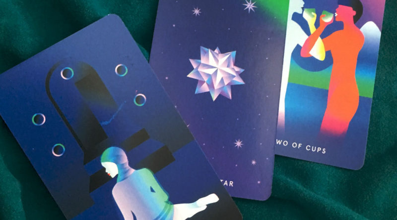 tarot cards laying on a teal cloth. What is blocking you from reaching your dreams? This tarot reading, pick a card format, will help you understand what you need to release to move forward.